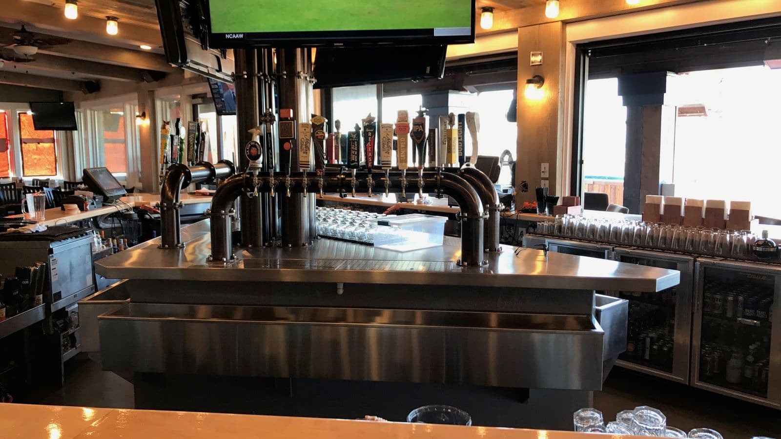 Custom stainless bar with multi-tap beer system over reclaimed wood
