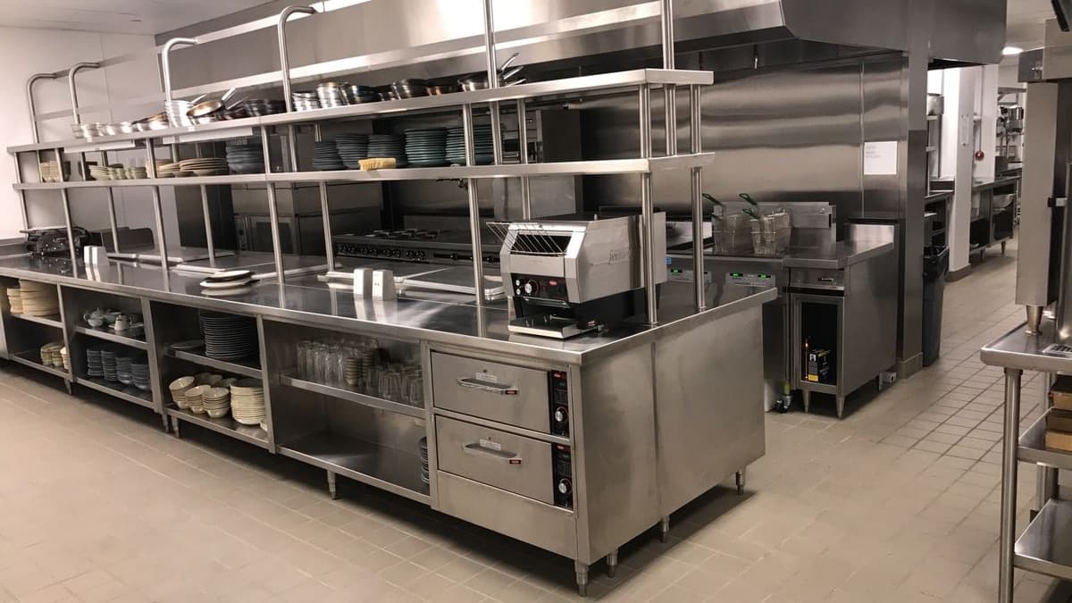 Stainless kitchen prep station with overhead shelving