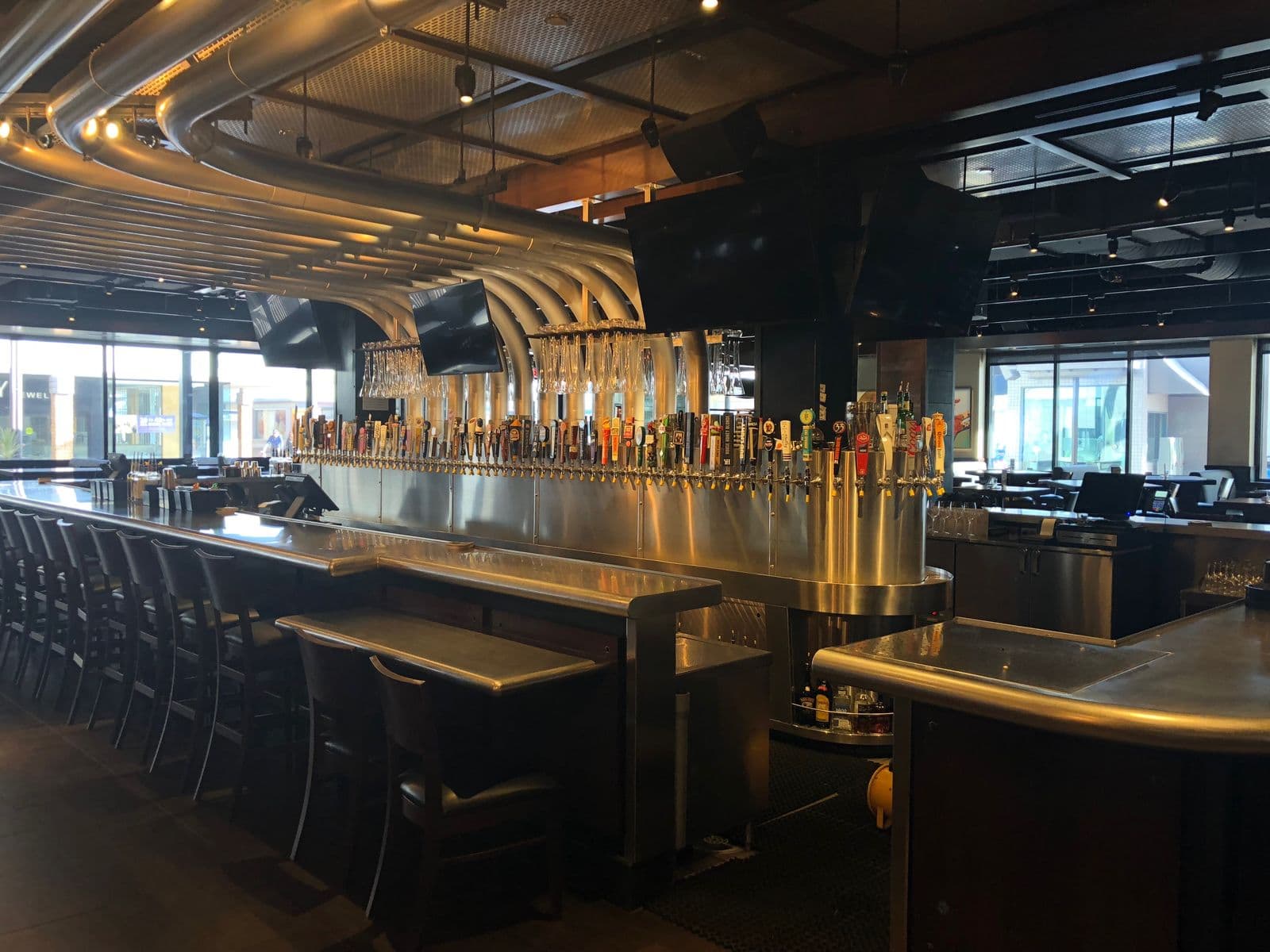Long stainless bar top and service station inside a finished restaurant