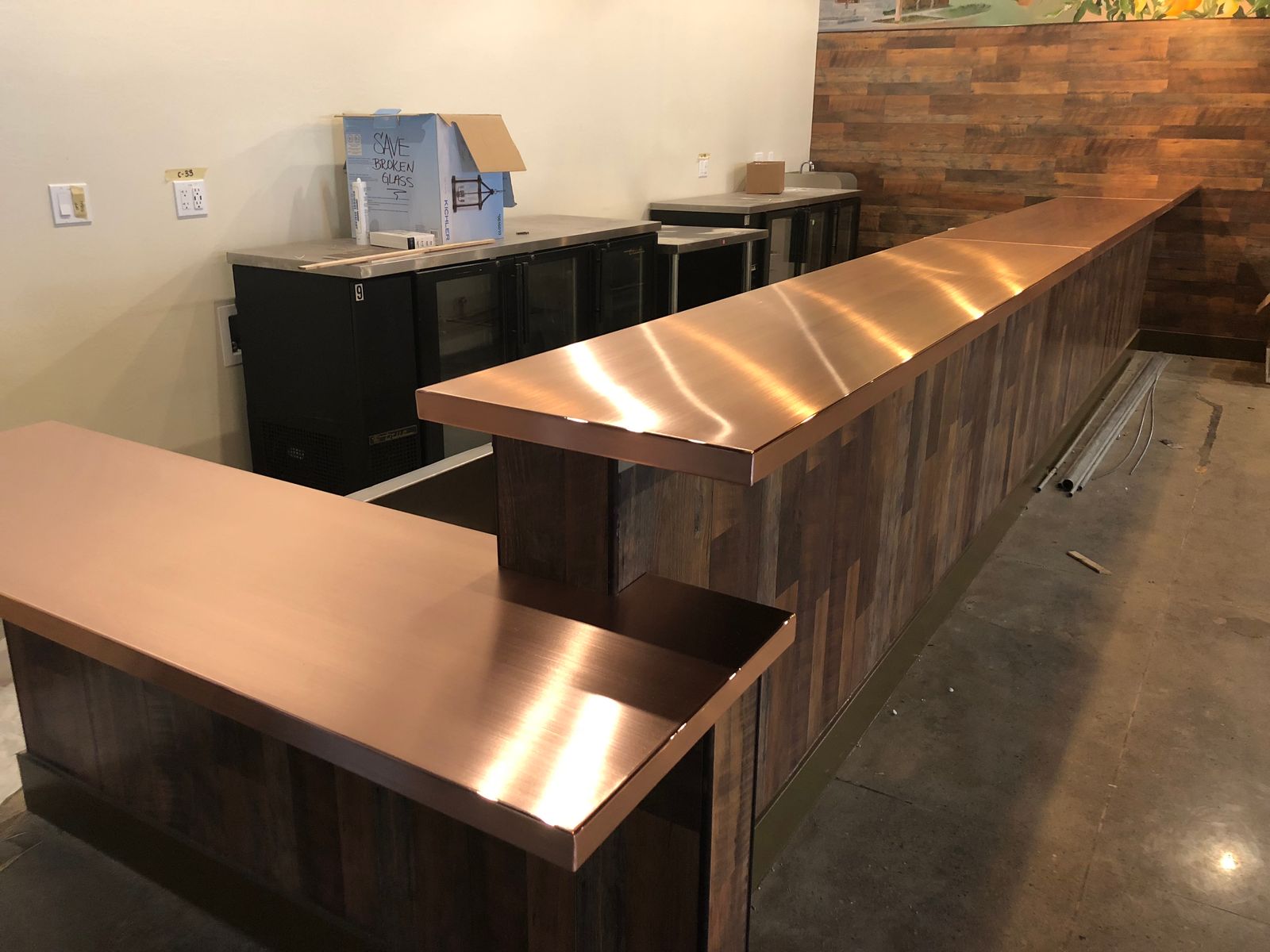 Copper bar top mounted on wood millwork